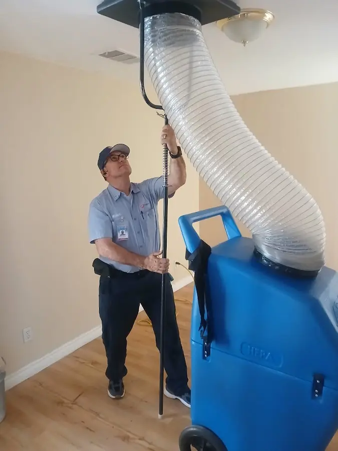 Furnace Tune-Up technician using HEPA equipment in Cibolo